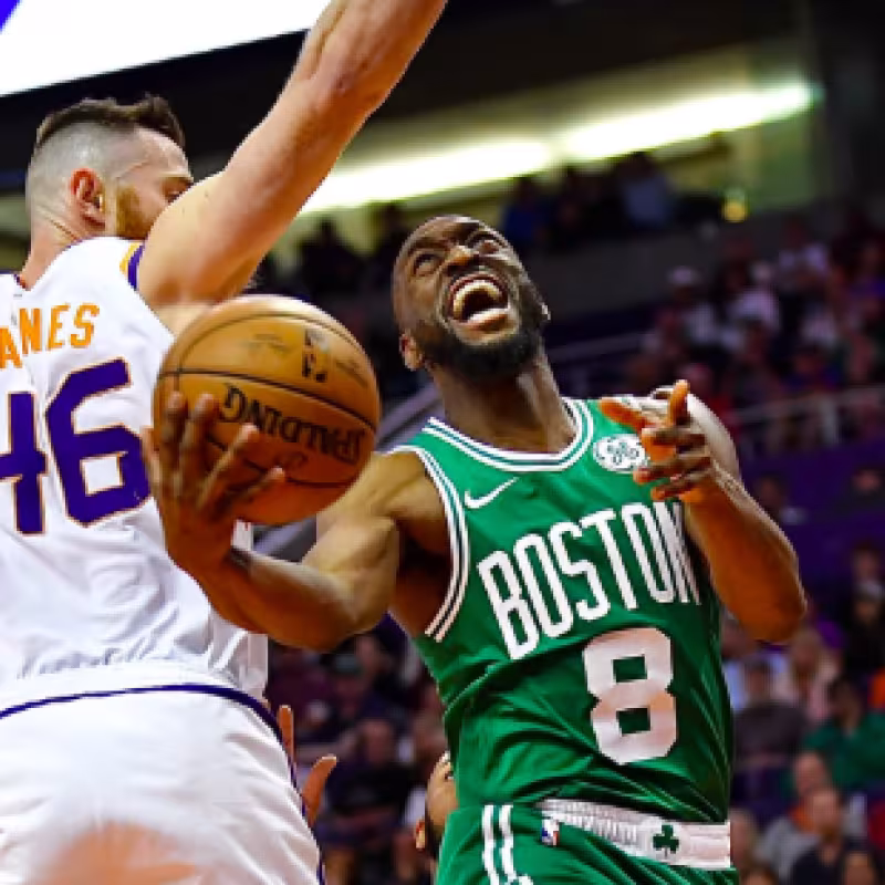 Kemba Walker penetra a canasta ante la oposición de Baines.
