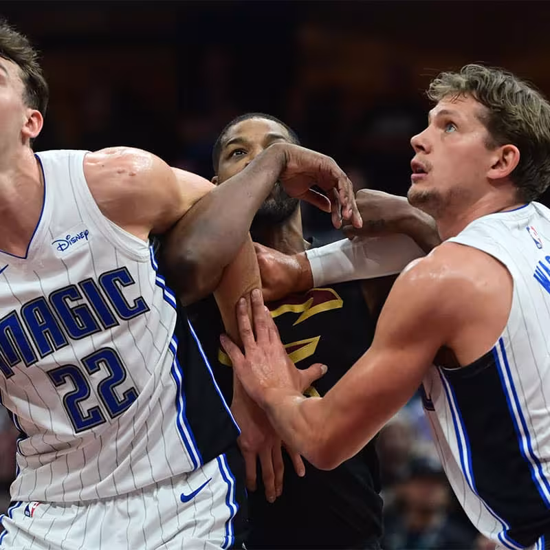 Franz Wagner and Moe Wagner, fighting with Tristan Thompson for a rebound.