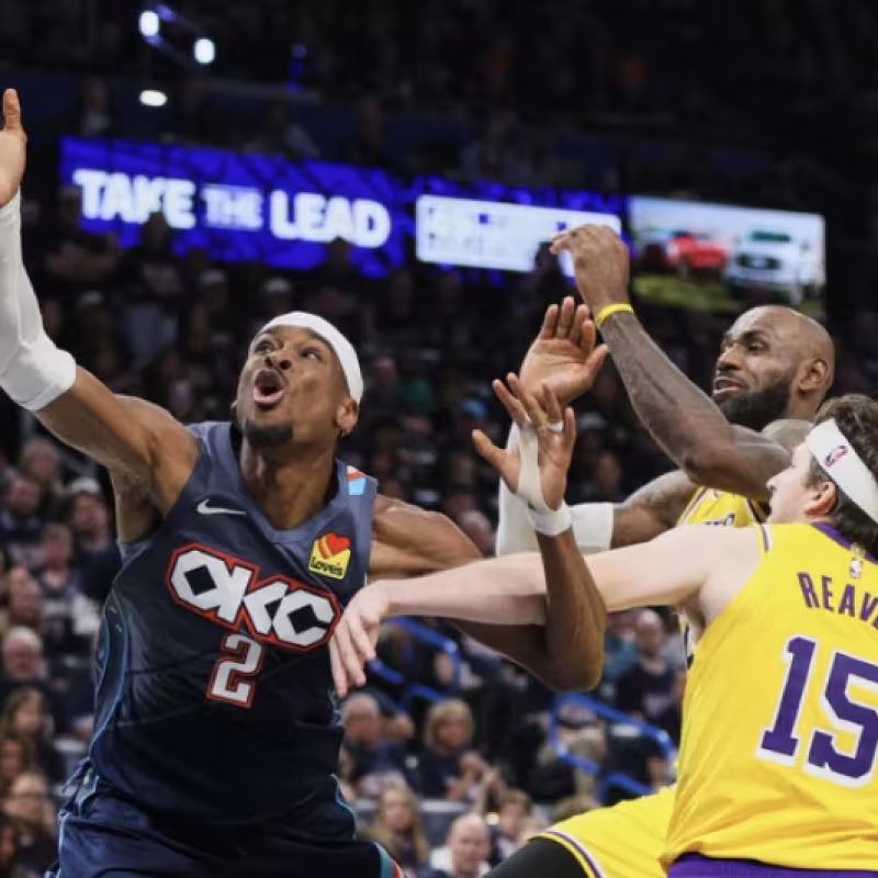 Shai Gilgeous-Alexander, simulating a foul against LeBron James and Austin Reaves.